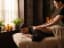 A massage therapist giving a client a back massage in a candlelit spa room